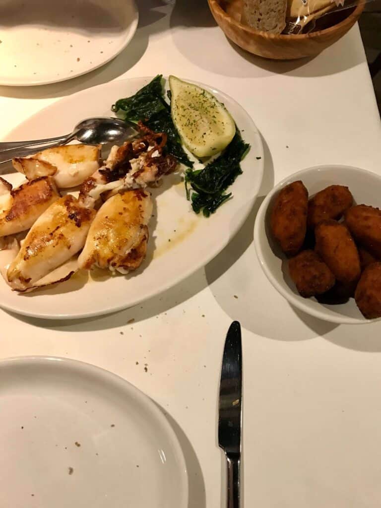 Mallorca Travel Itinerary in 4 Days 24 Grilled squid with sides and croquettes.