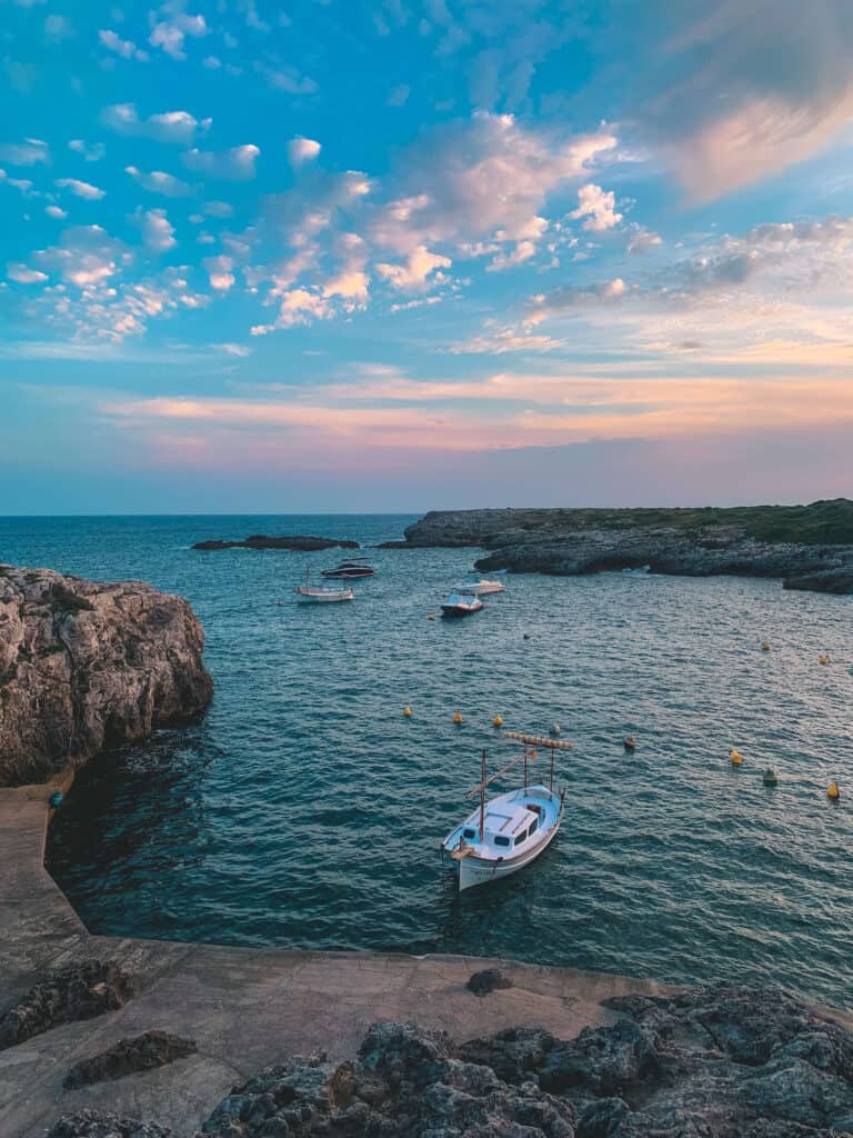 Exploring the Best Beaches in Menorca 8 Serene coastal scene with boats in Binibeca, Menorca