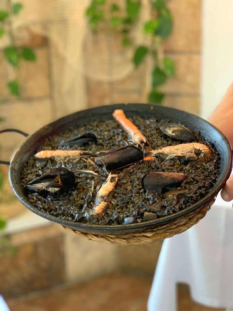 Black rice paella with seafood