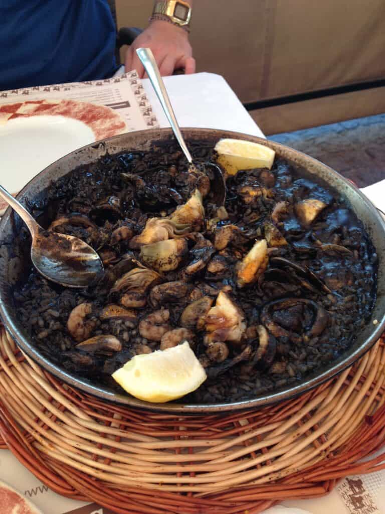 Black rice seafood dish with lemon