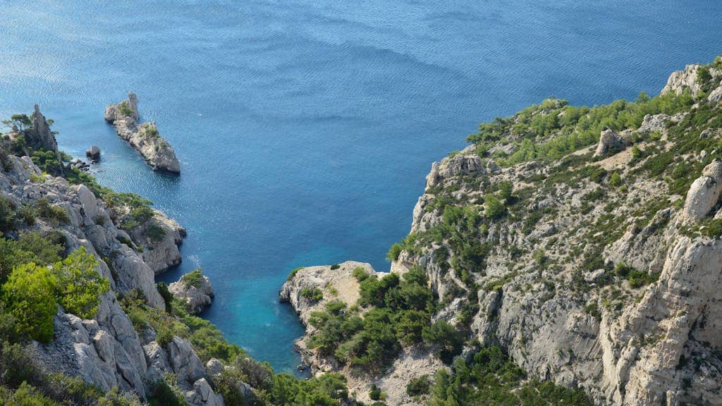 South of France Itinerary in 7 days 4 Breathtaking aerial view of rocky coastline and blue sea at Calanques, Marseille, France in a South of france itinerary in 7 days