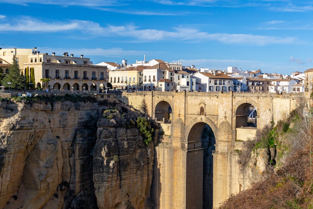 Southern Spain Itinerary 10 Days 16 Breathtaking view of the iconic Puente Nuevo bridge spanning the gorge in Ronda, Spain on a sunny day.