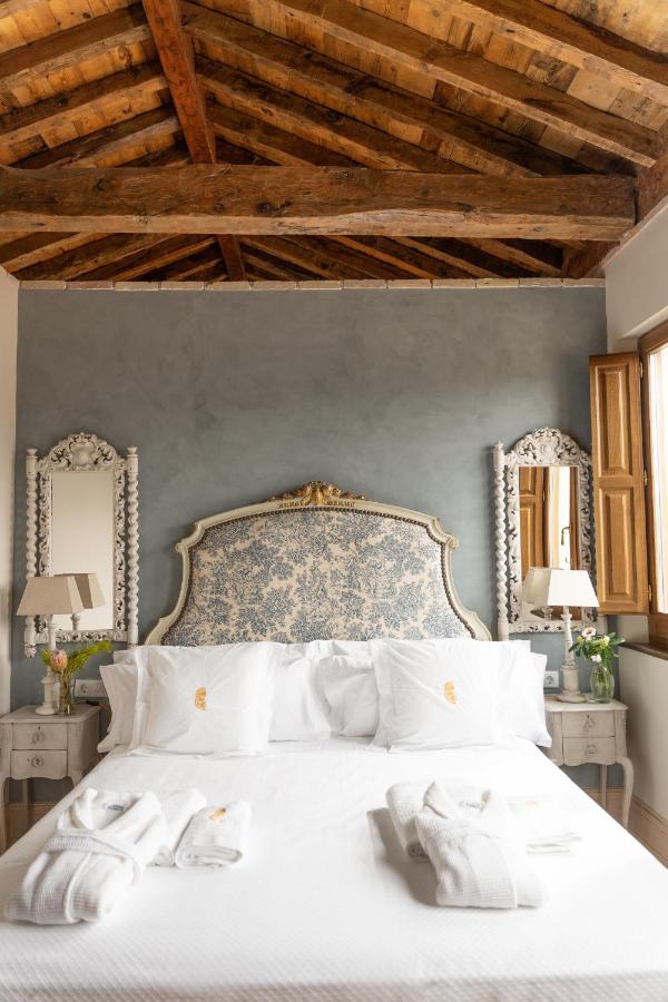Granada in Two Days Itinerary: Local Guide 9 Elegant room with rustic wooden ceiling.