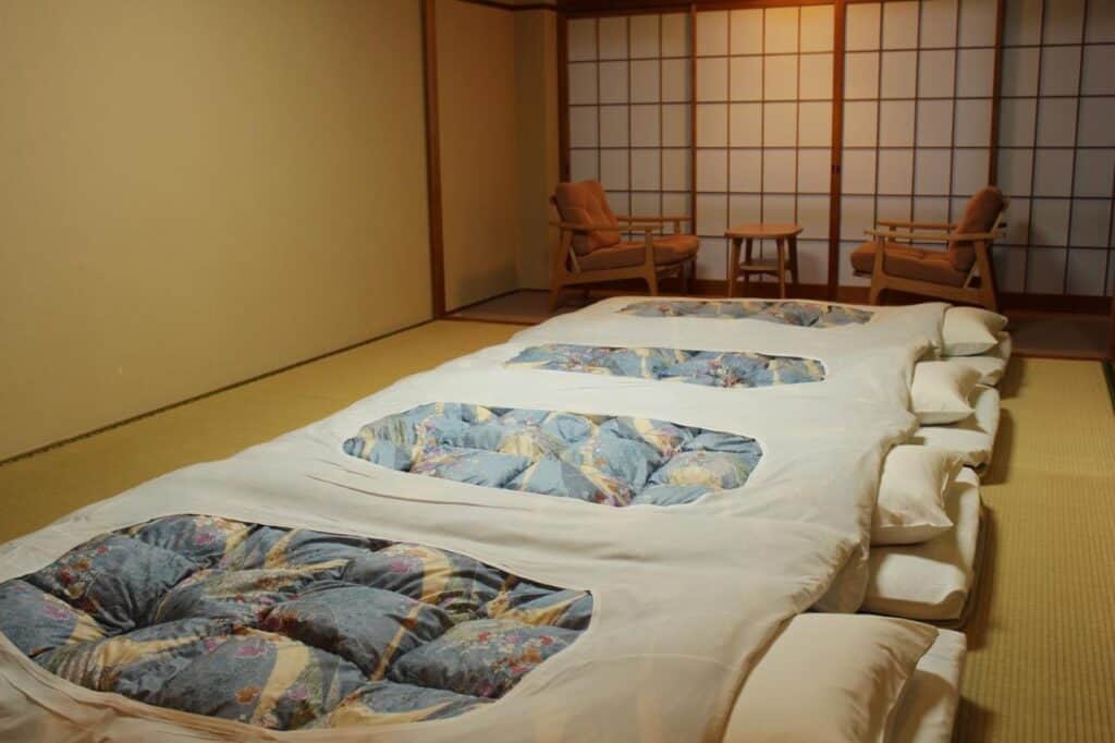 8 UNIQUE Miyajima Ryokans, Hiroshima 25 Traditional tatami room with futons