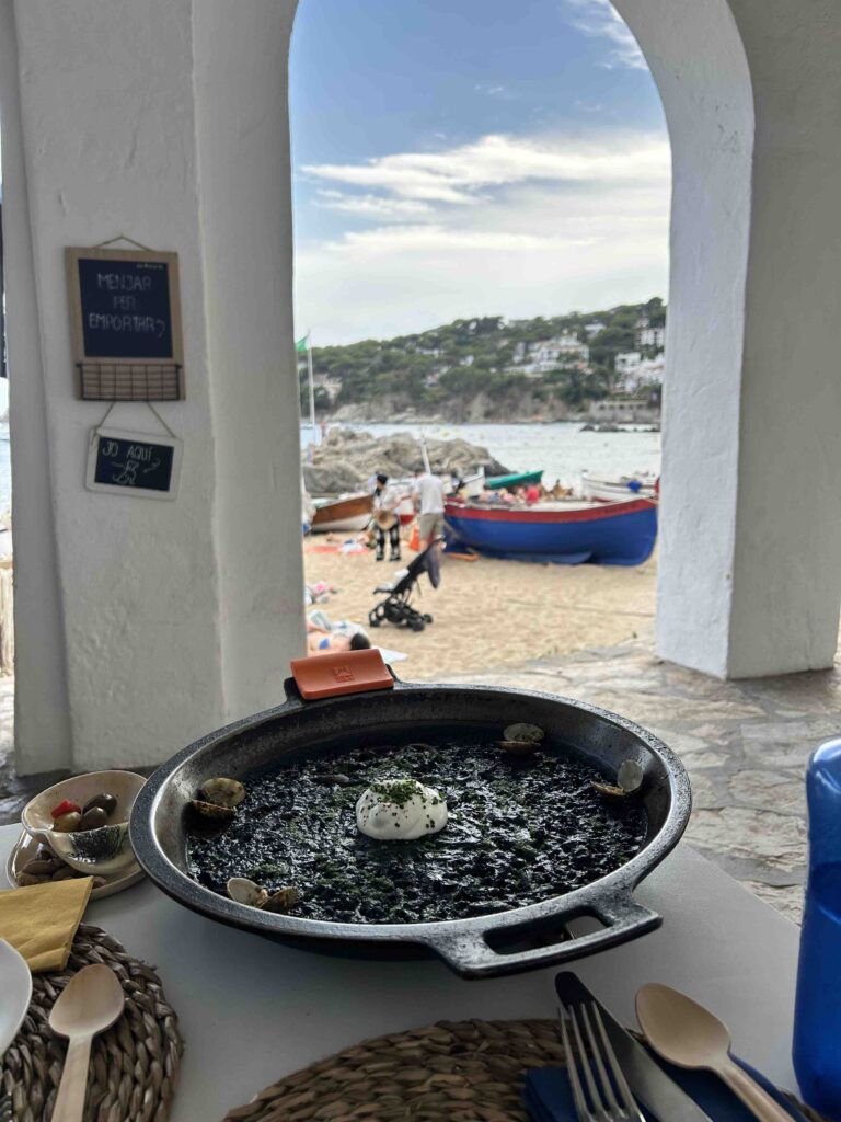 Complete 7 day Costa Brava Itinerary 12 Black rice paella with beach view.