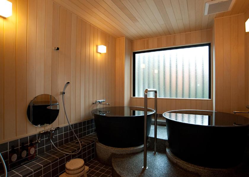 8 UNIQUE Miyajima Ryokans, Hiroshima 35 Modern indoor onsen with wooden decor