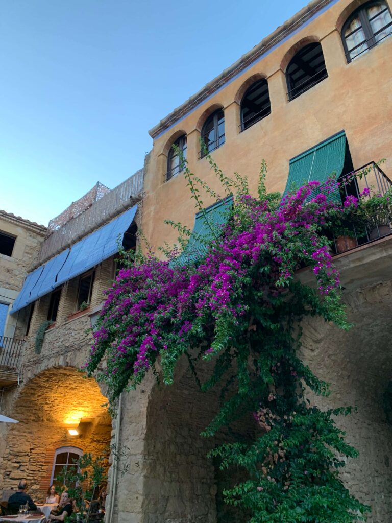 Complete 7 day Costa Brava Itinerary 14 Charming stone building with vibrant flowers.