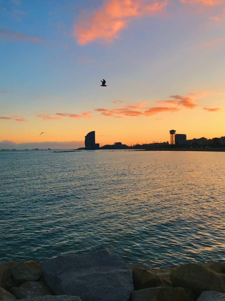 3 day itinerary in Barcelona: Local Guide 16 Colorful sunset over calm ocean waters.
