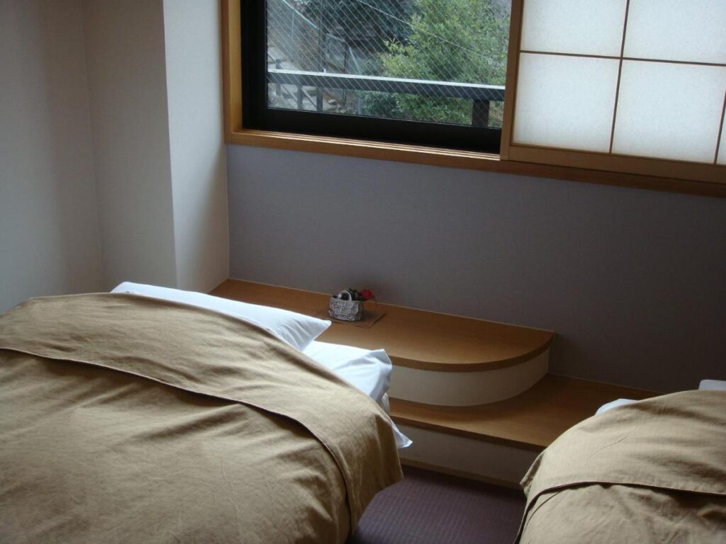 8 UNIQUE Miyajima Ryokans, Hiroshima 32 Traditional Japanese ryokan bedroom interior.