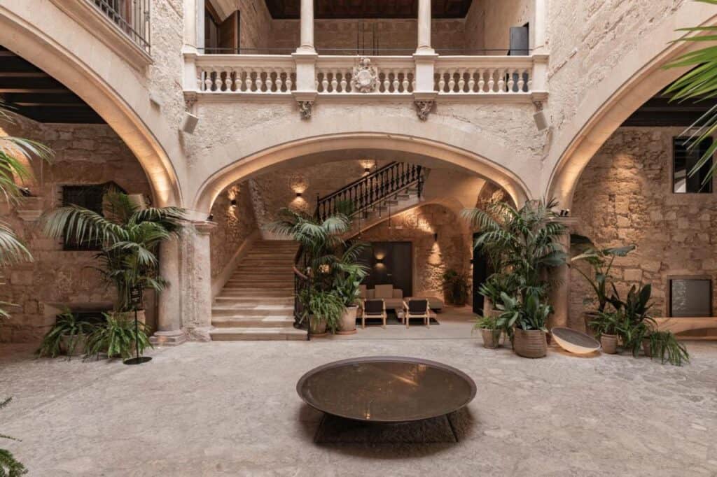 Mallorca Travel Itinerary in 4 Days 11 Elegant courtyard with lush greenery.