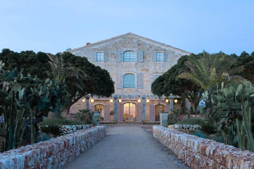 Exploring the Best Beaches in Menorca 10 Elegant stone Son Vell hotel in Menorca surrounded by greenery.