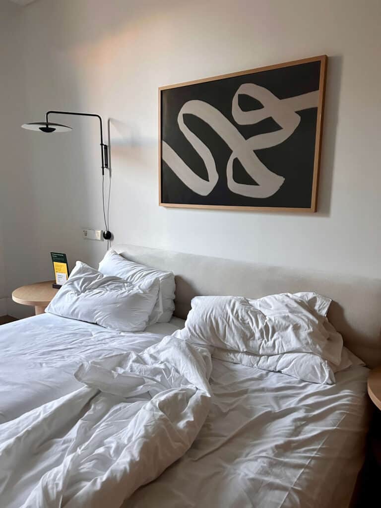 3 day itinerary in Barcelona: Local Guide 9 Messy bed with abstract wall art