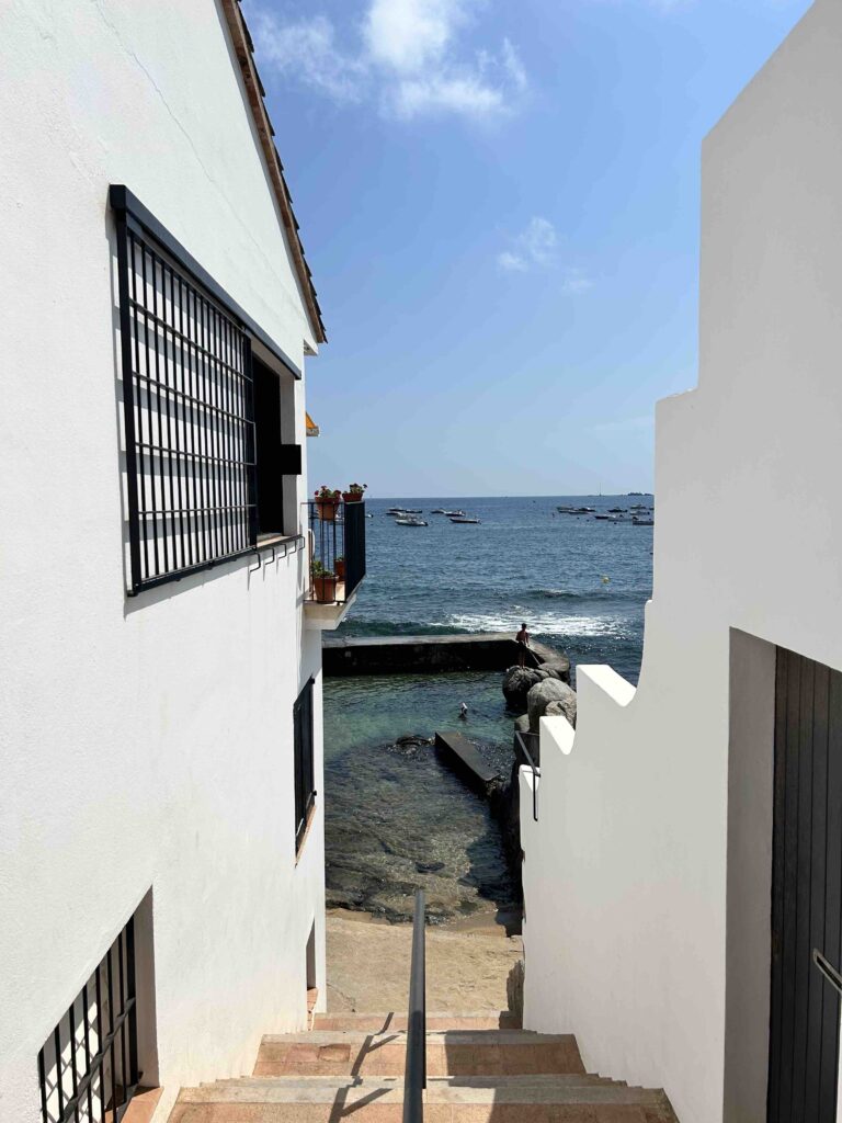 Complete 7 day Costa Brava Itinerary 11 Stairs leading to a serene beach.