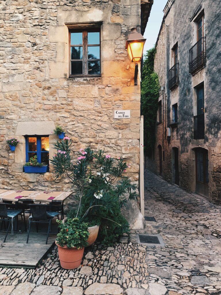 Complete 7 day Costa Brava Itinerary 15 Charming cobblestone street with plants.