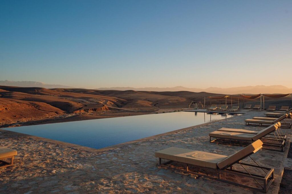 8 SPECTACULAR Agafay Desert Camps 10 swimming pool at sunset time in oxygen lodge, one of the best agafay desert camps in morocco