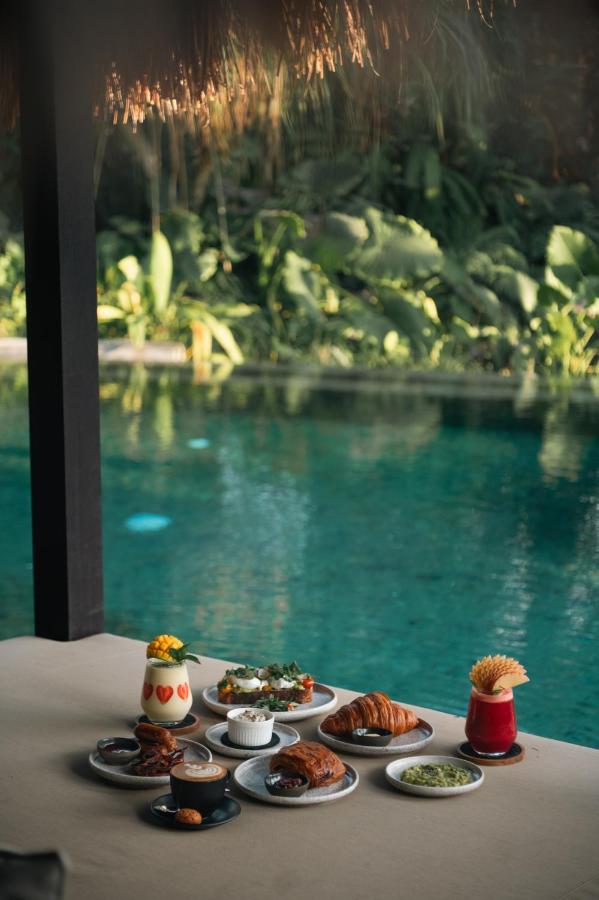 14 UNIQUE Boutique Hotels in Canggu, Bali 58 breakfast by the pool at desa hay luxury boutique hotel, one of the best boutique hotels in canggu bali
