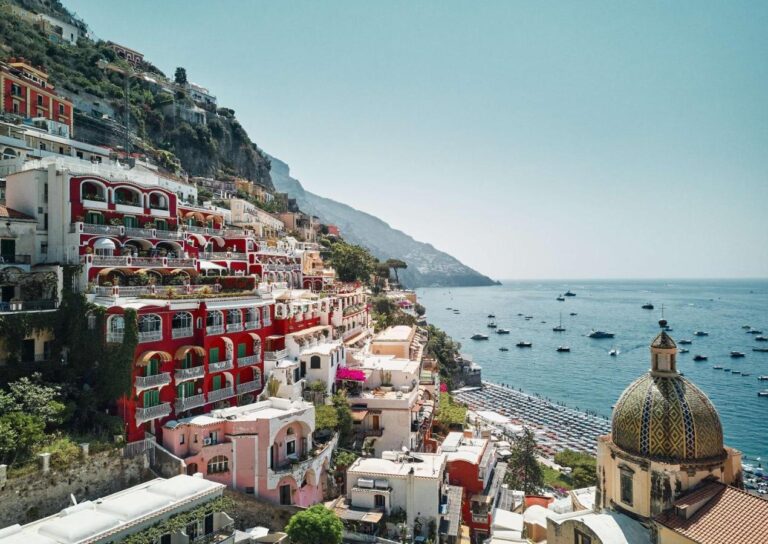 Le Sirenuse's colorful red facade and terrace, one of my favorite boutique hotels on the Amalfi Coast