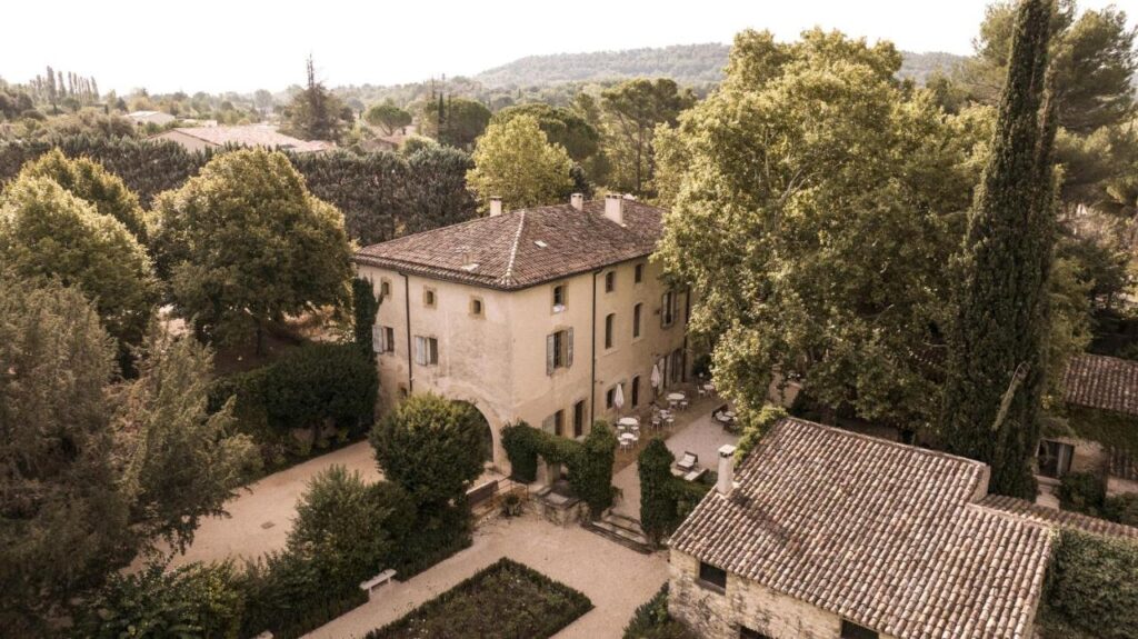 11 Unique Places to Stay in Provence 6 sky view of elegant building and facade of le galinier lourmarin chateau hotel, one of the most unique places to stay in provence, south of france