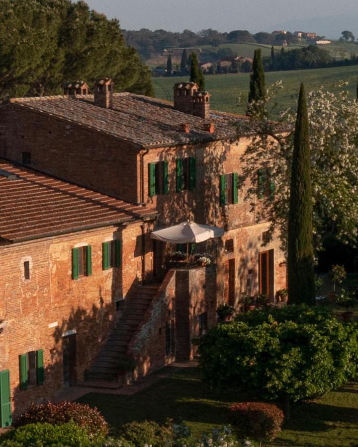 traditional stone facade with wooden windows at villa cozzano, one of the best agriturismos in tuscany, italy