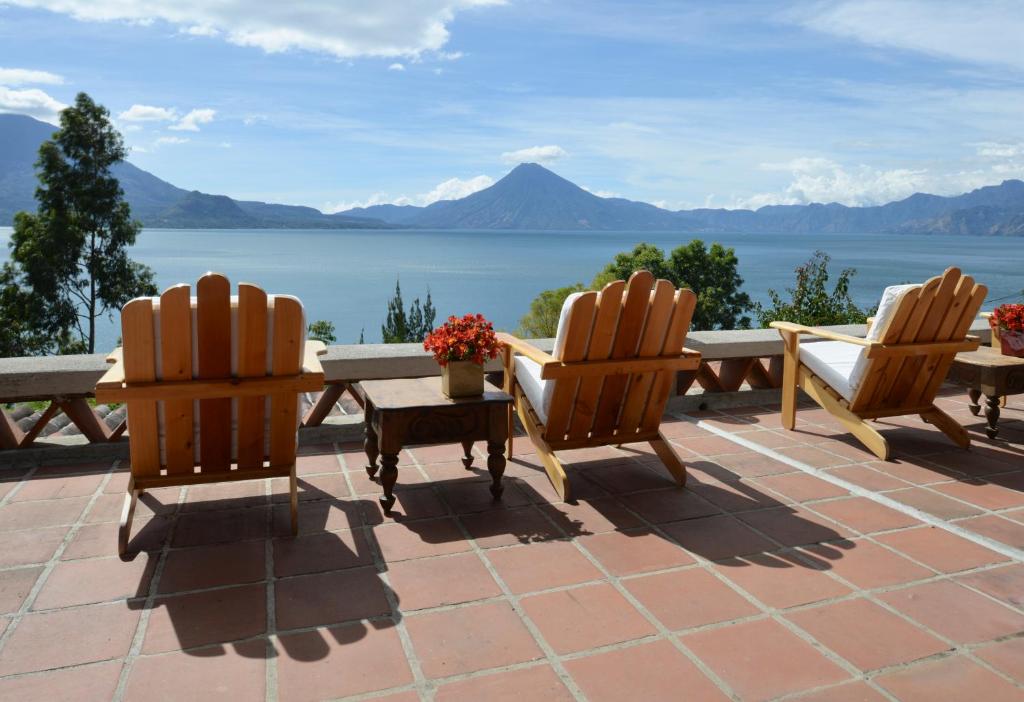 8 UNIQUE Places Where to Stay in Lake Atitlán 17 deck chairs in terrace with lake views at Casa Palopo hotel, one of the best places where to stay in lake atitlán, guatemala