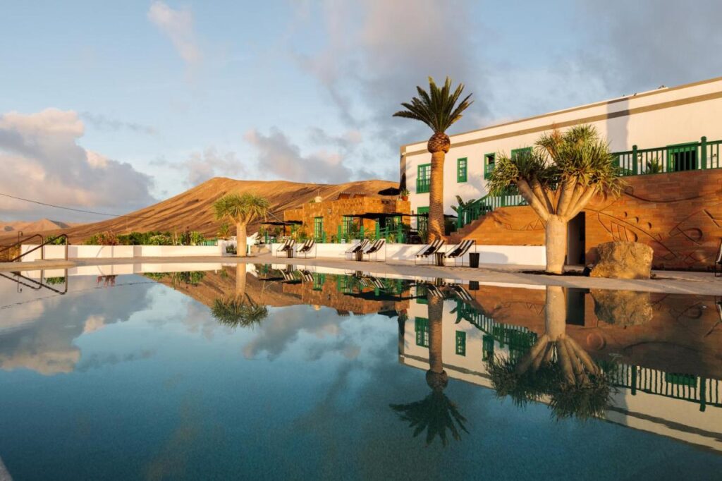 Unique Adults Only Hotels in Lanzarote 1 swimming pool and facade at sunset time at cesar lanzarote, one of my favorite adults only hotels in lanzarote spain