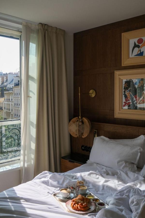 breakfast in bed with city views at pulitzer hotel, one of the most unique hotels in paris, france