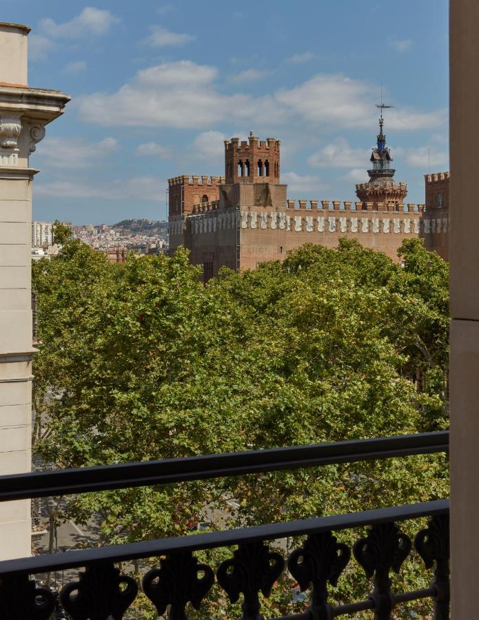 13 Unique Hotels in Barcelona, Spain 18 Castle view with green trees.