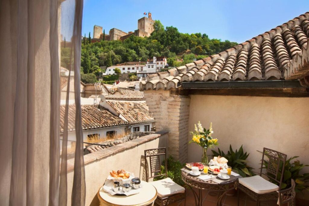 view of alhambra from room terrace at casa 1800, one of the best boutique hotels in Granada Spain
